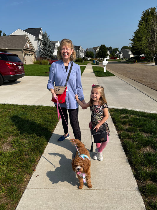 woman walking her dog with her granddaughter